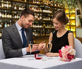 Image showing man proposing to his girlfriend at restaurant