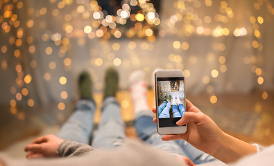 Image showing close up of couple taking foot photo by smartphone