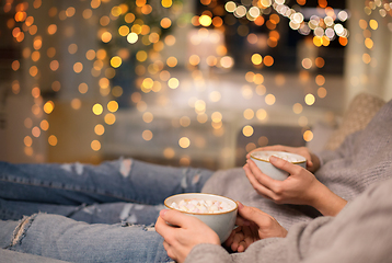Image showing close up of couple drinking hot chocolate at home