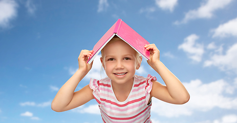 Image showing little girl with roof of book on top of her head