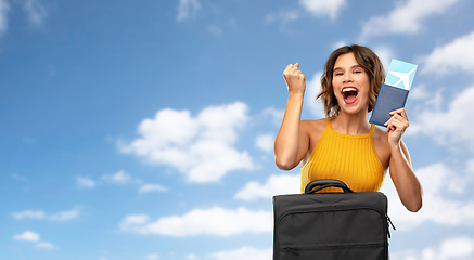 Image showing happy young woman with air ticket and travel bag