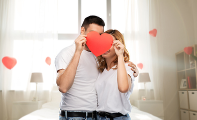 Image showing couple hiding behind red heart on valentines day