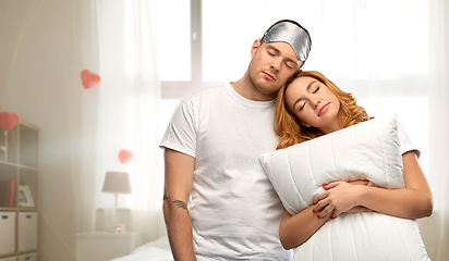 Image showing couple with eye sleeping mask and pillow at home