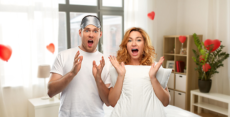 Image showing scared couple with eye sleeping mask and pillow