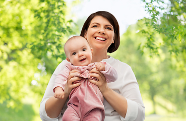 Image showing happy middle-aged mother with little baby daughter