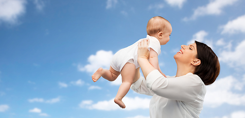 Image showing happy middle-aged mother with little baby daughter