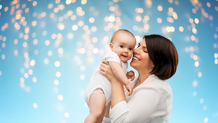 Image showing happy middle-aged mother with little baby daughter