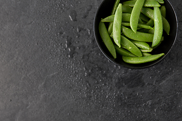 Image showing peas in bowl on wet slate stone background