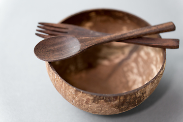 Image showing close up of coconut bowl, wooden spoon and fork