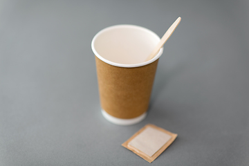 Image showing disposable paper coffee cup with spoon and sugar