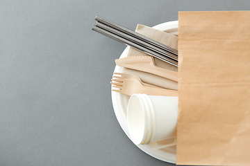 Image showing wooden forks, knives and paper cups on plate