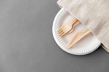 Image showing wooden forks and knives on paper plates and napkin