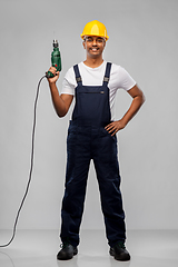 Image showing happy indian builder in helmet with electric drill