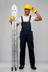 Image showing happy indian builder in helmet with ladder