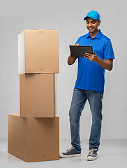 Image showing indian delivery man with tablet pc and boxes
