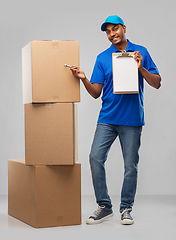 Image showing indian delivery man with boxes and clipboard