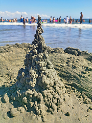 Image showing Sand castle and crowded beach background