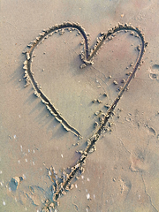 Image showing Drawing heart symbol on sand