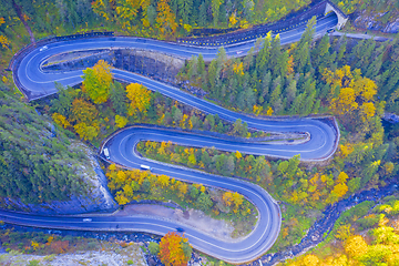 Image showing Windinding road in autumn forest from above