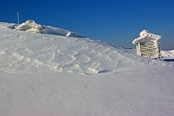 Image showing Snow covered weather station on mountain top