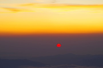 Image showing Sunrise at the horizon over mountains