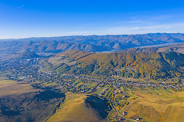 Image showing Aerial view of village and autumn mountain