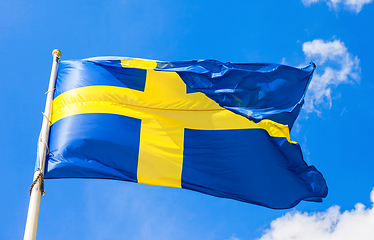 Image showing Swedish flag blue with yellow cross waving in the wind against a