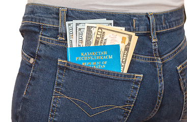 Image showing Kazakhstan passport and dollar bills in the back jeans pocket. M