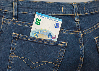 Image showing Banknote 20 euro sticking out of the back jeans pocket. Money fo