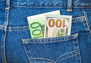 Image showing Blue jeans pocket with one hundred euro and one hundred american