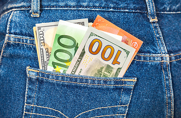 Image showing Euro and american currency, money in jeans pocket for travel and