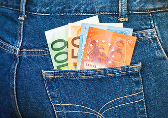 Image showing Euro banknotes sticking out of the blue jeans pocket. Money for 