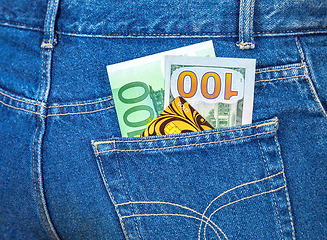 Image showing Blue jeans pocket with one hundred euro, one hundred american do