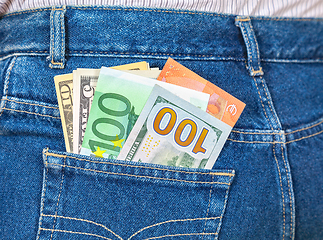 Image showing Euro and american currency, money in jeans pocket for travel and