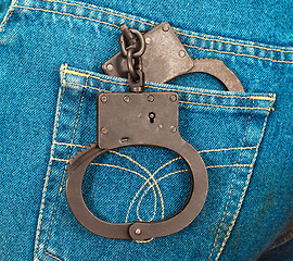 Image showing Police steel handcuffs in back jeans pocket