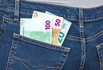 Image showing Euro banknotes sticking out of the blue jeans pocket. Money for 