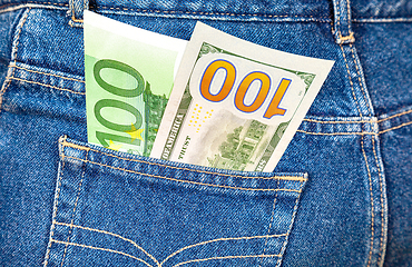Image showing Blue jeans pocket with one hundred euro and one hundred american
