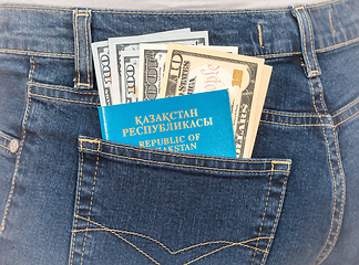 Image showing Kazakhstan passport and dollar bills in the back jeans pocket. M