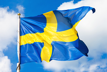 Image showing Swedish flag blue with yellow cross waving in the wind against a