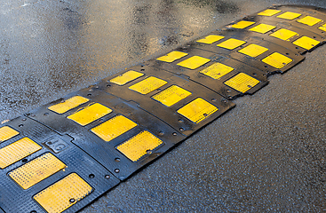 Image showing Traffic safety speed bump on an asphalt road