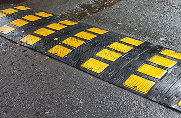 Image showing Traffic safety speed bump on an asphalt road