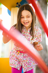 Image showing Cute little girl is playing in playground