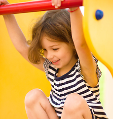 Image showing Cute little girl is playing in playground