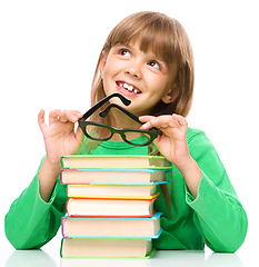 Image showing Little girl is reading a book