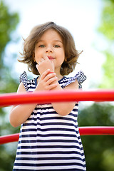 Image showing Cute little girl is playing in playground