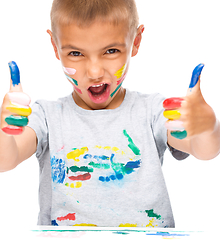 Image showing Portrait of a cute boy playing with paints