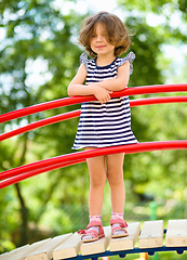 Image showing Cute little girl is playing in playground