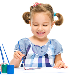 Image showing Little girl is painting with gouache