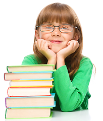 Image showing Little girl is reading a book