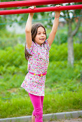 Image showing Cute little girl is playing in playground